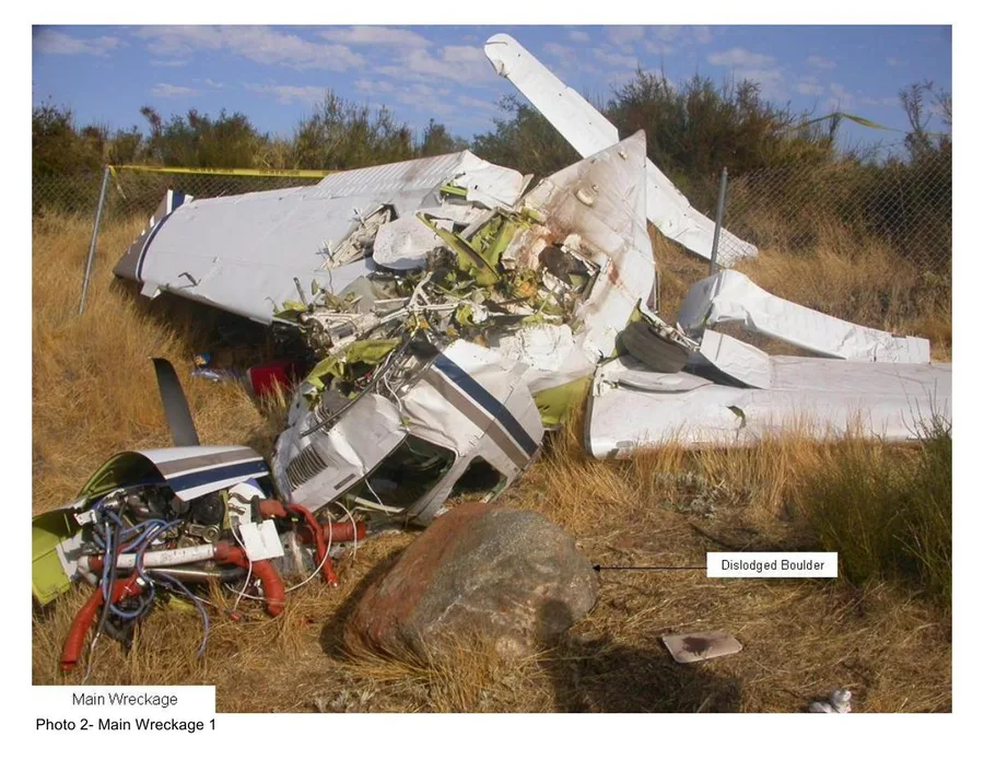 NTSB photo of the main wreckage, with the dislodged boulder marked