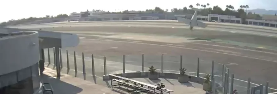 NTSB final report figure: security-camera image of the airplane in a near-vertical attitude just before it climbed out of frame and crashed